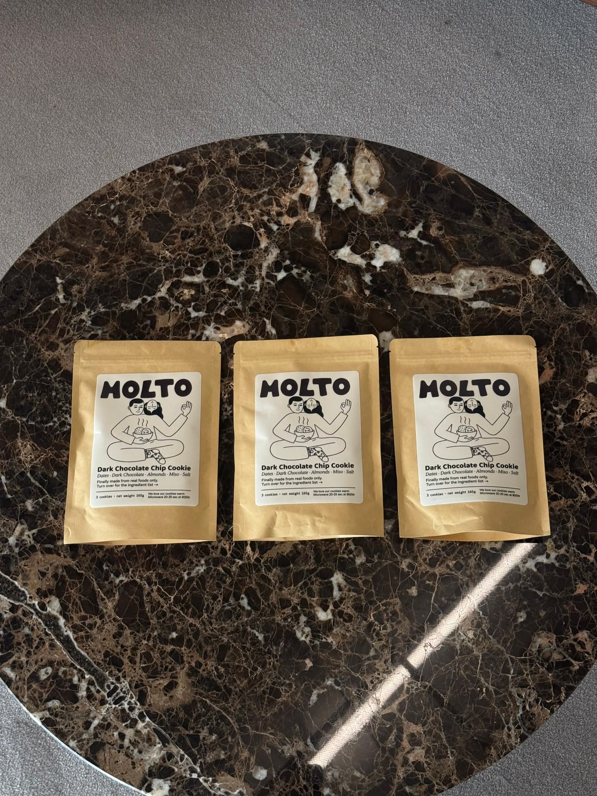 Three MOLTO cookie pouches on a marble table