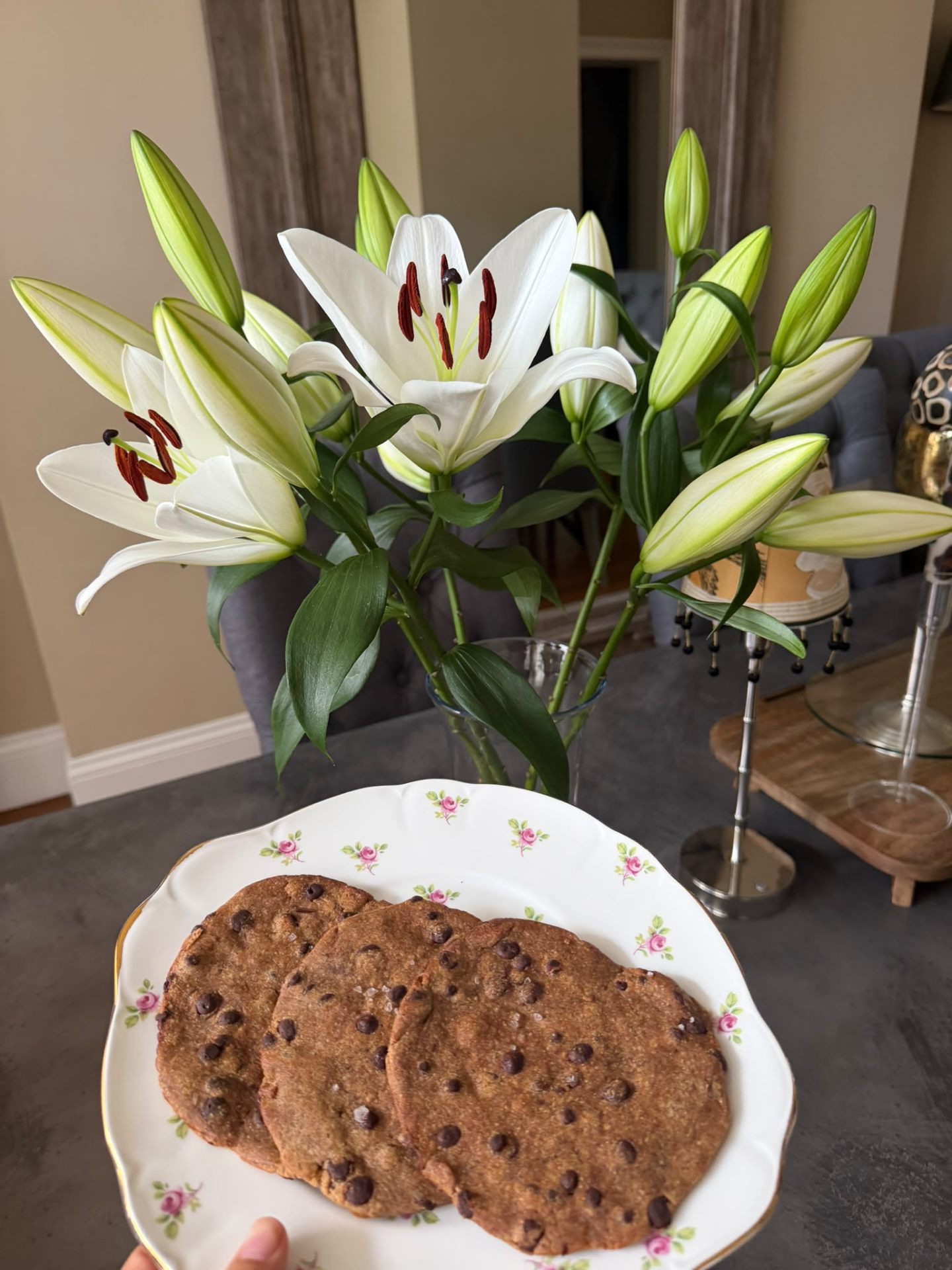 MOLTO cookies on a floral plate in front of white lilies