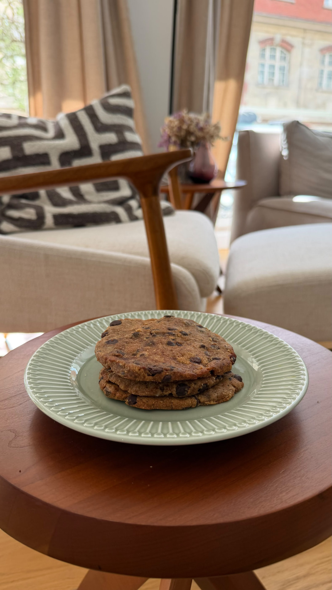 Stack of MOLTO cookies on a green plate on a wooden side table