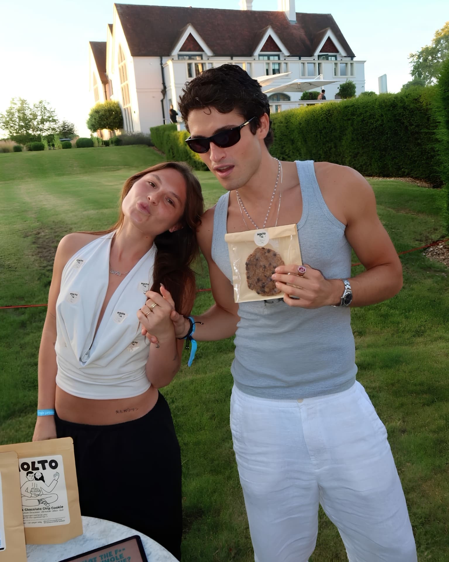 MOLTO founders Virgo and Sofia holding a MOLTO cookie