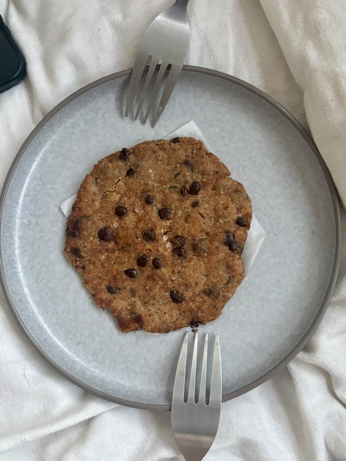 MOLTO cookie on a grey plate with two forks